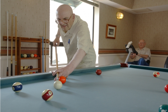 Senior Living Residents playing pool at Daystar Retirement Village in West Seattle